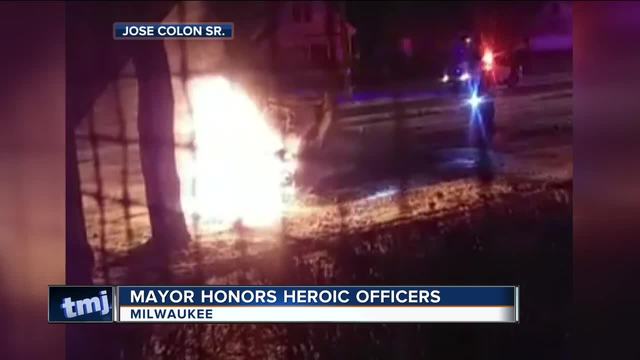 Dramatic police video captures auto crash and rescue from burning vehicle